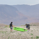 People carry a boat over dry ground at Lake Mead, which is drying up due to overuse and drought.